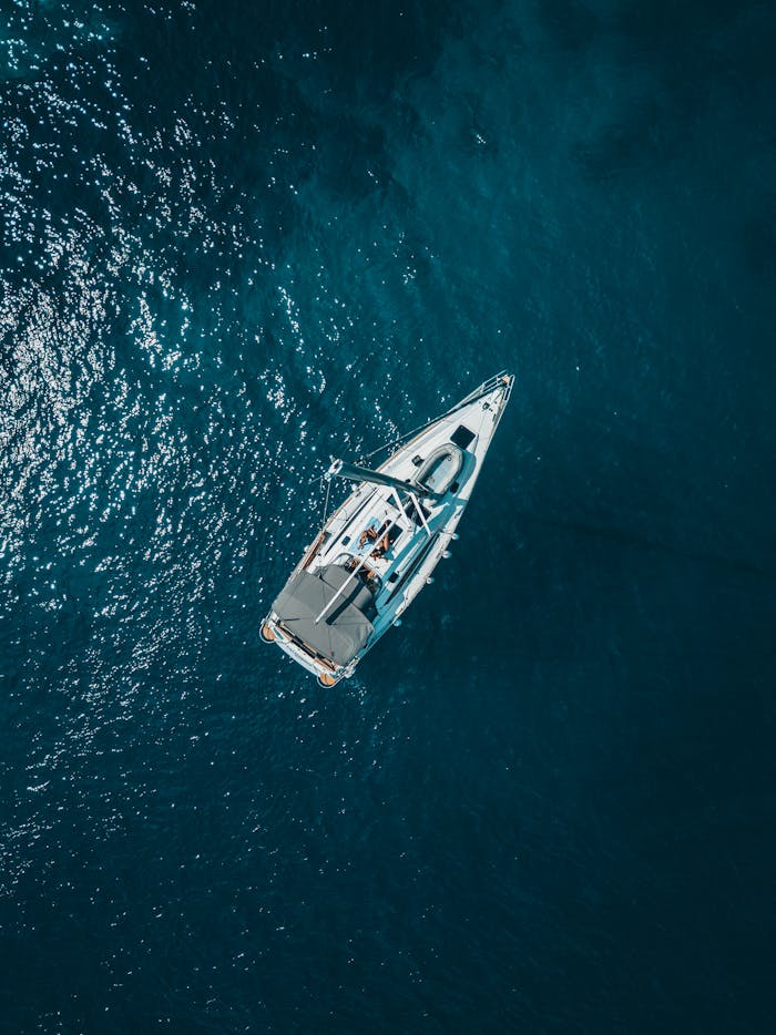 services-05 A stunning aerial shot of a sailboat cruising the deep blue waters of Croatia.