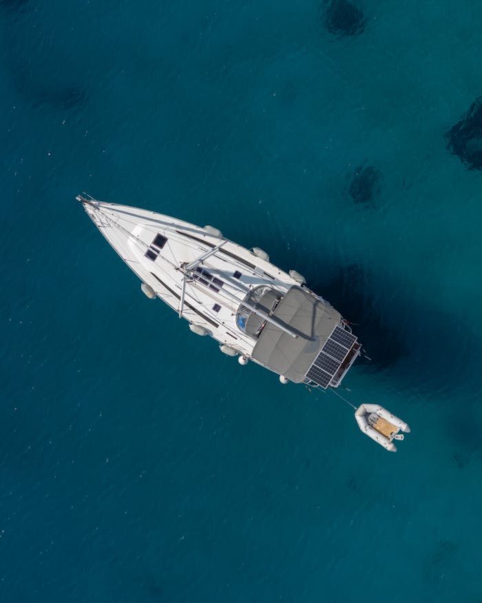 Aerial view of a luxury yacht anchored in the crystal-clear waters of Bodrum, Türkiye.